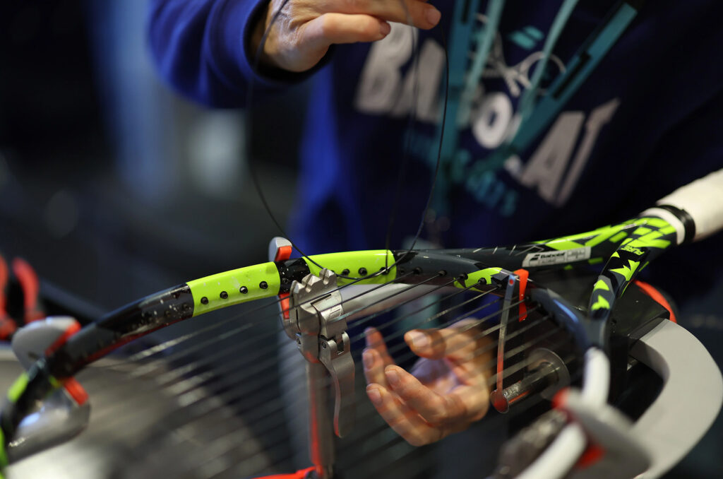 Racquet being restrung.