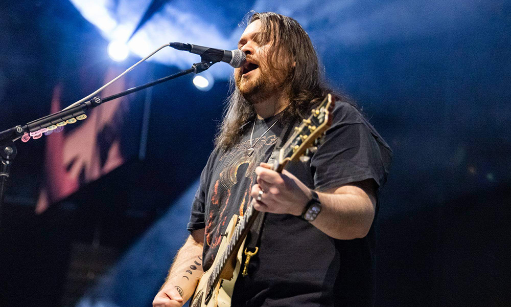 Wolfgang Van Halen singing and playing his guitar.