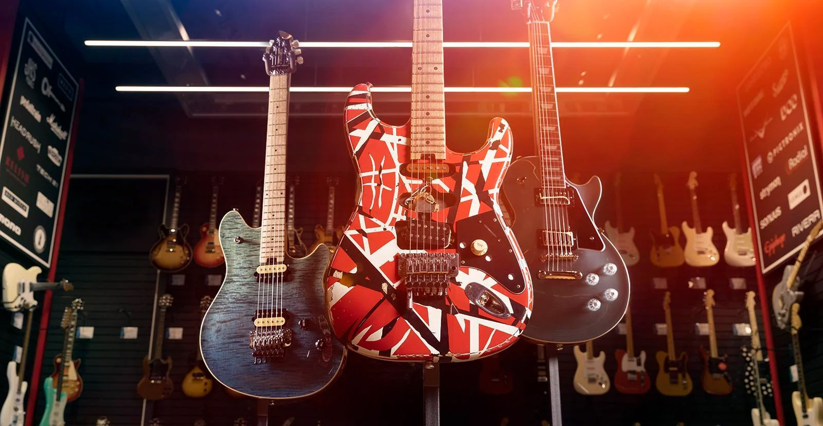 Unstrung store with 3 guitars hanging 