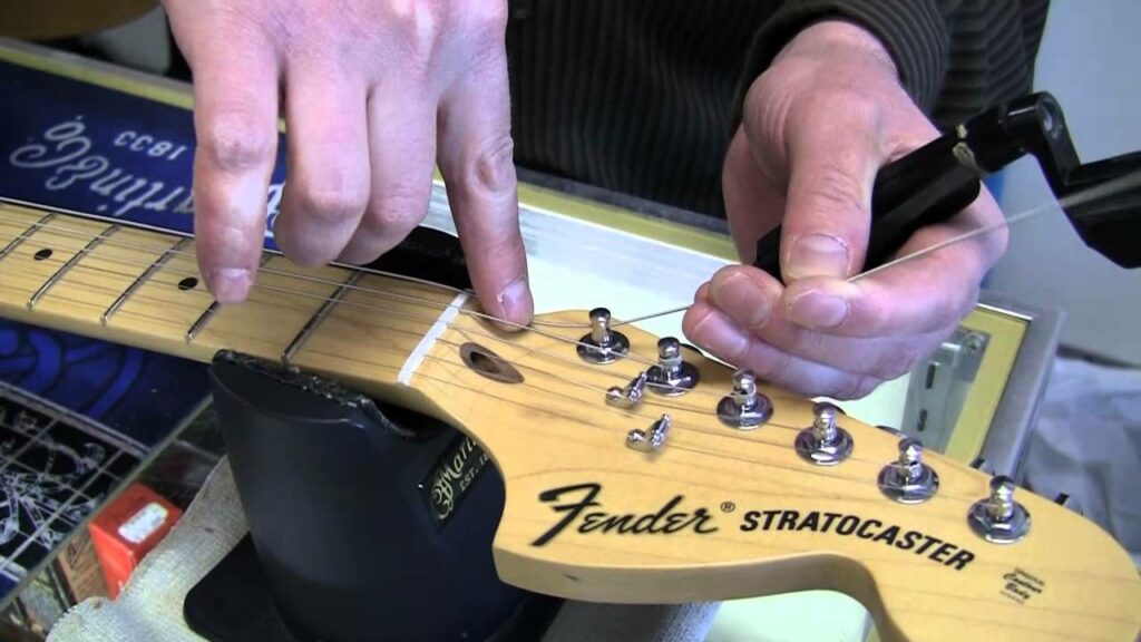 Guitar being restrung
